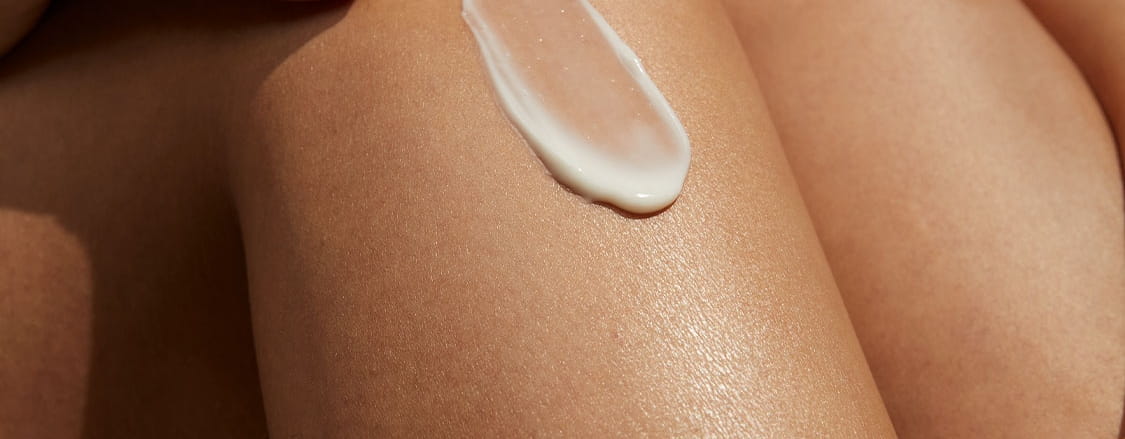 woman wiping her face clean with face wipes
